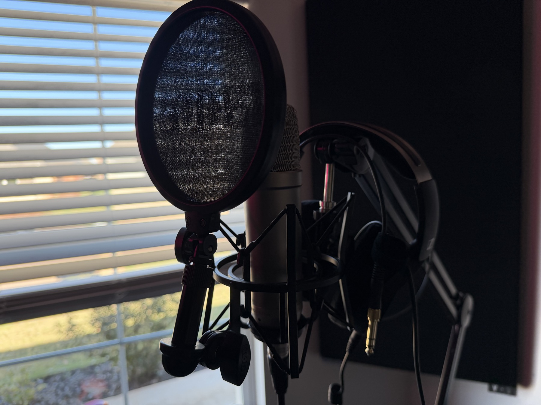 Studio recording microphone with pop filter and headphones